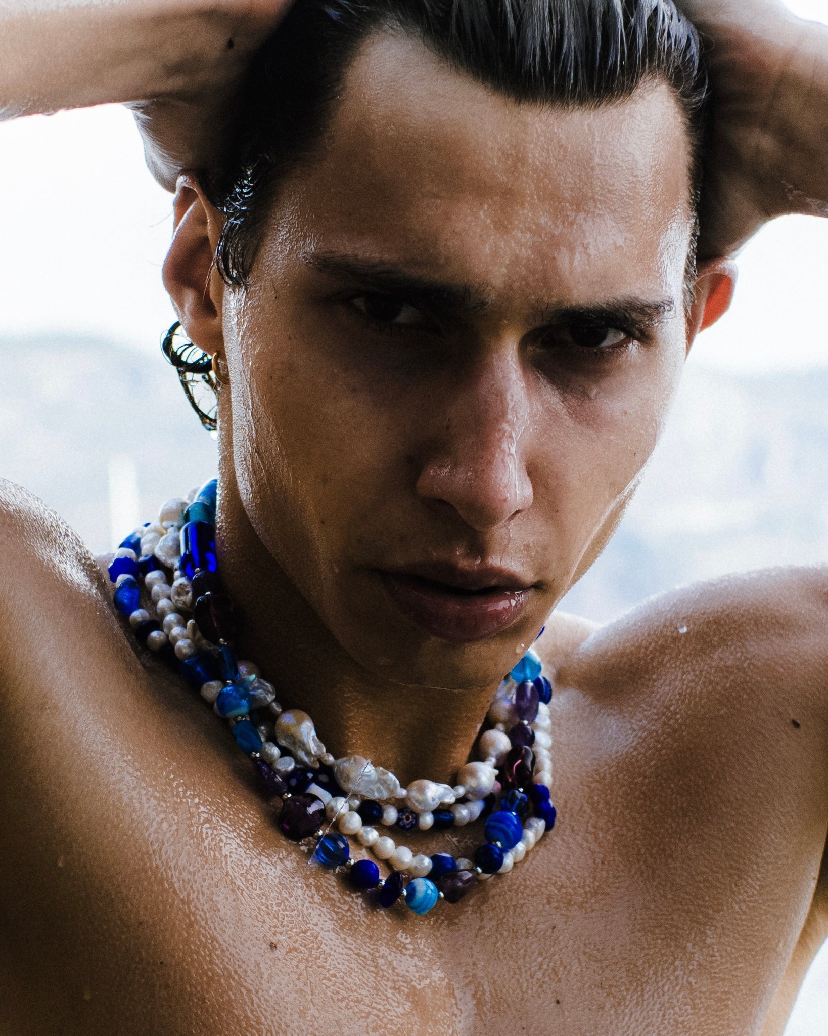 Sporty man wears several WHYAT chains.