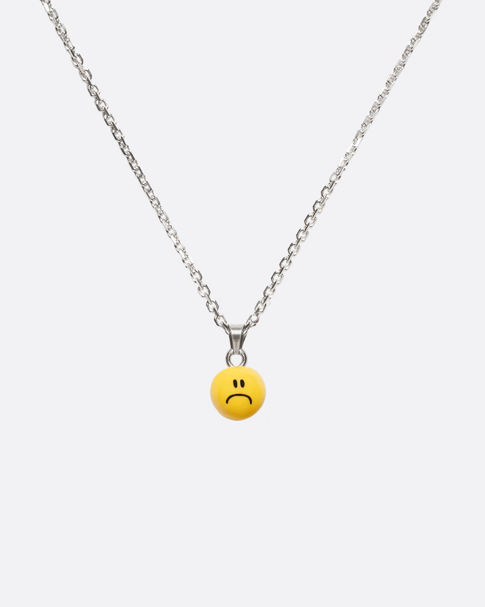 necklace with sad smiley pendant