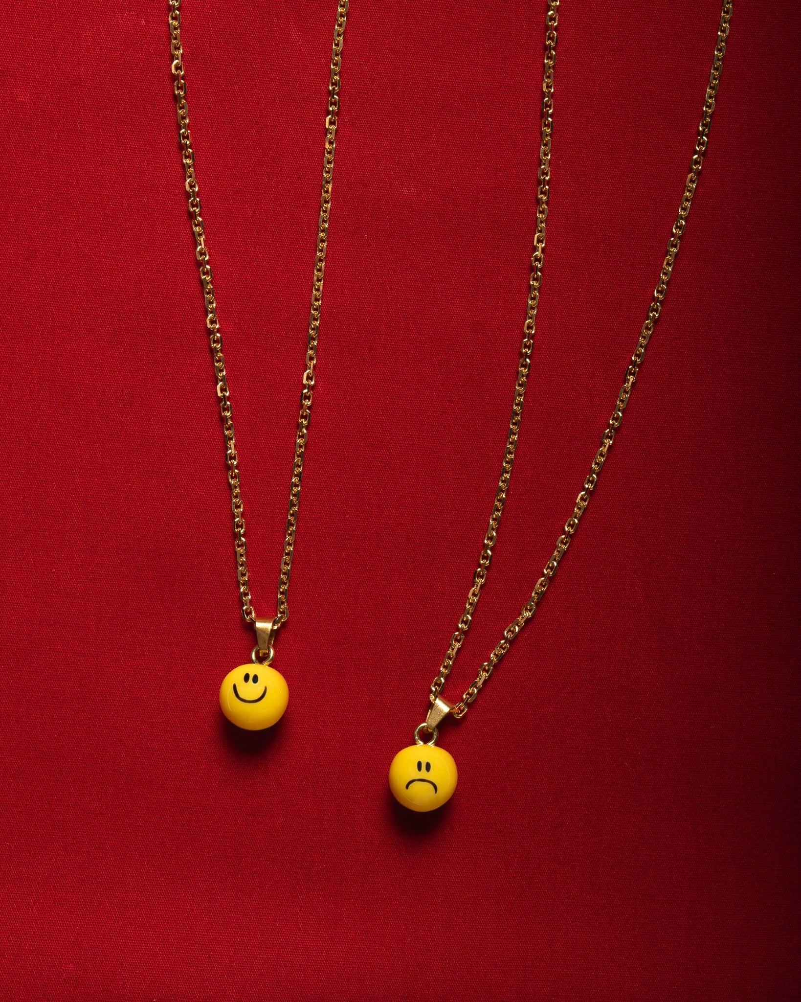 necklace with happy and sad smiley