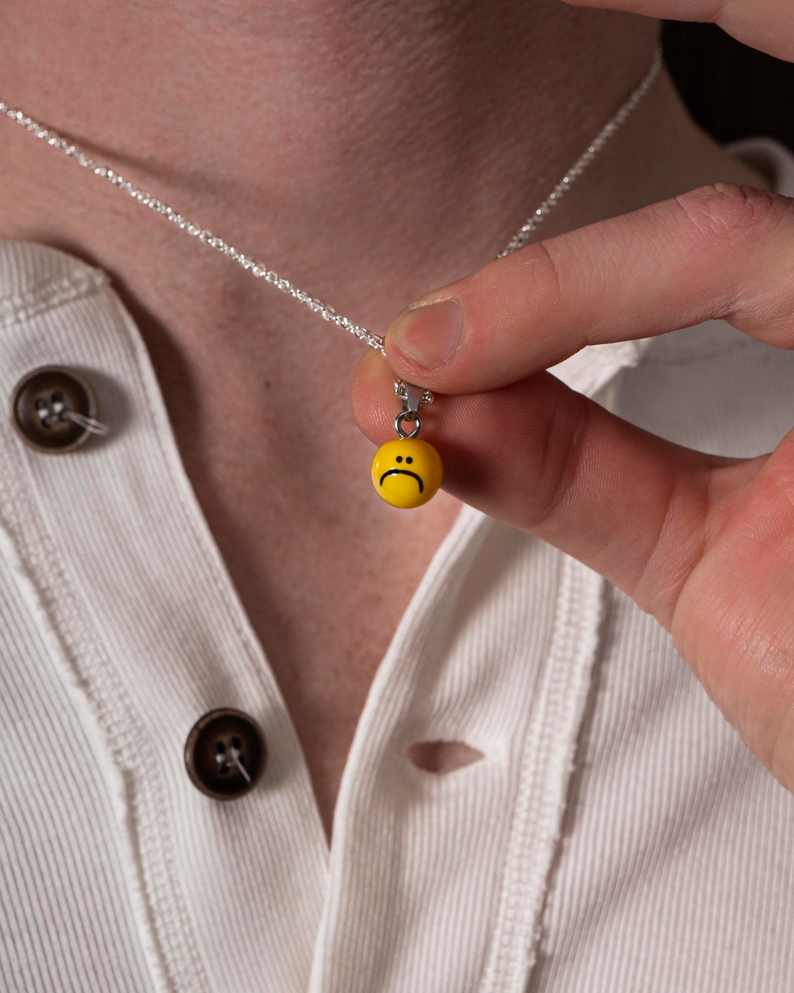 necklace with sad smiley face